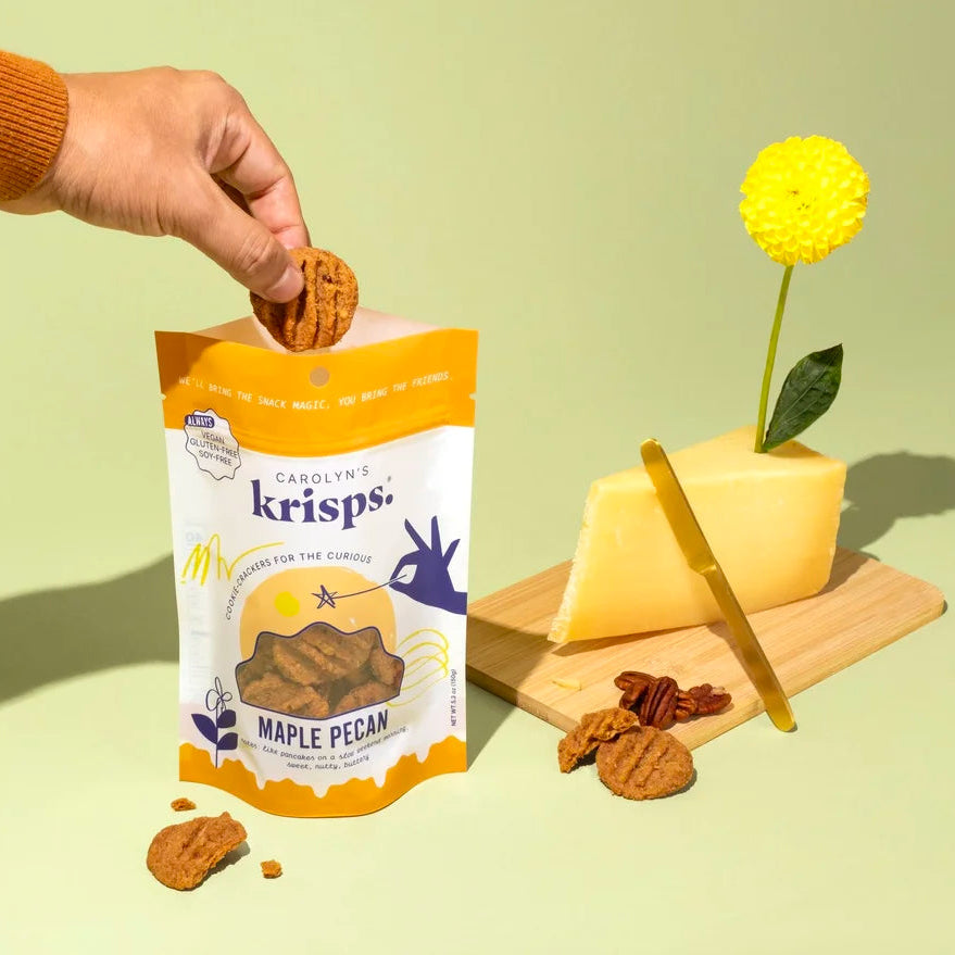 Maple Pecan flavor Carolyn's Krisps with a suggested pairing of cheese and sunshine